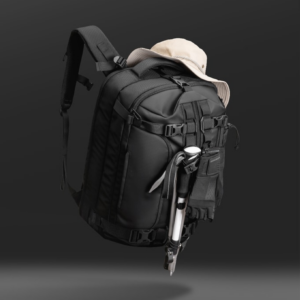 A multi-panel spec sheet titled 'KEY FEATURES AT A GLANCE' detailing the Cinomadist Motion A Backpack. It showcases its 28L structured capacity, center-line access, 17+ pocket organization, compression system, tech protection, and durable 1800D/1260D nylon fabrics.